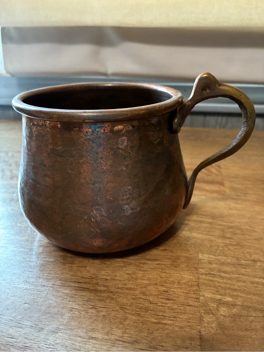 hand-hammered copper mug with a  handle.
